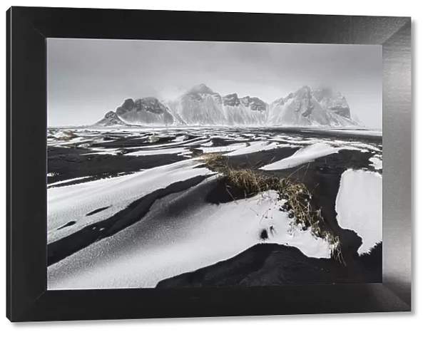 Iceland, East Iceland, Austurland, Black and white dunes on beach after blizzard