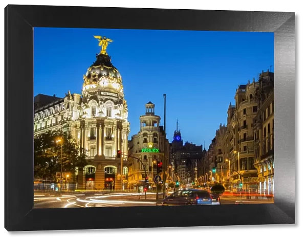 Night view of Gran Via street and Metropolis Building with car light trails, Madrid