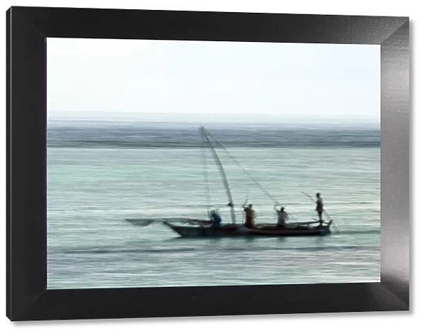 Fishing boat in the Indian Ocean, pre-dawn, East Coast Unguja Island, Zanzibar, Tanzania