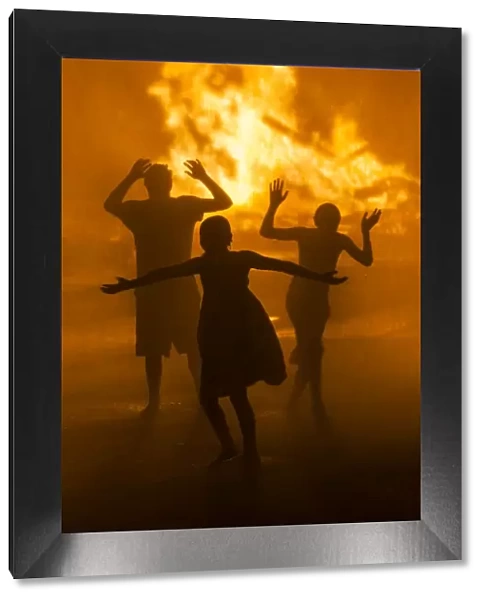 USA, Massachusetts, Cape Ann, Rockport, Fourth of July Bonfire, silhouettes of people