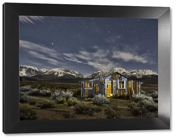 Abandoned cabin at night with Sierra Nevada mountains in back, Mono Lake, Eastern Sierra
