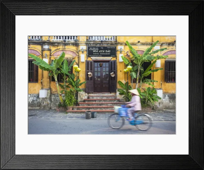 Framed Print : Woman riding bicycle past restaurant, Hoi An (UNESCO World Heritage Site), Quang Ham