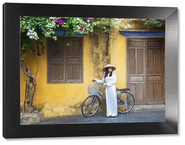 Woman wearing Ao Dai dress with bicycle, Hoi An (UNESCO World Heritage Site), Quang Ham