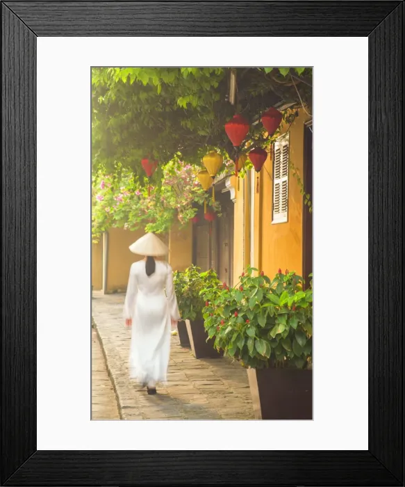 Framed Print : Woman wearing Ao Dai dress walking along street, Hoi An (UNESCO World Heritage Site) Framed Print : Woman wearing Ao Dai dress walking along street, Hoi An (UNESCO World Heritage Site)