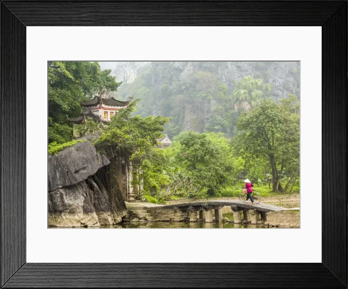 Framed Print : Woman crossing bridge with bicycle to temple, Tam Coc nr Ninh Binh, nr Hanoi, Vietnam Framed Print : Woman crossing bridge with bicycle to temple, Tam Coc nr Ninh Binh, nr Hanoi, Vietnam