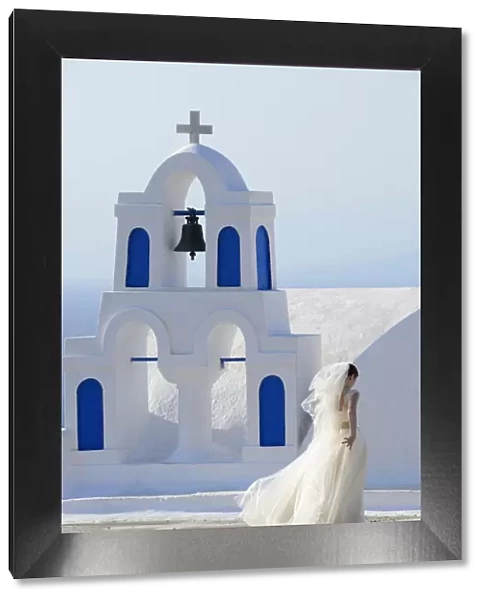Bride walking past church, Santorini, Kyclades, South Aegean, Greece, Europe