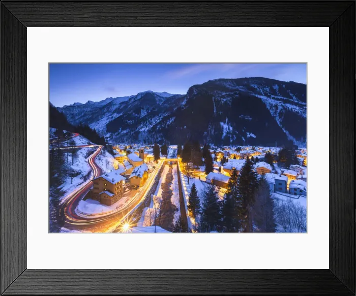 Framed Print : Campodolcino village lights up at dusk after a snowfall, Spluga valley, Sondrio province Framed Print : Campodolcino village lights up at dusk after a snowfall, Spluga valley, Sondrio province