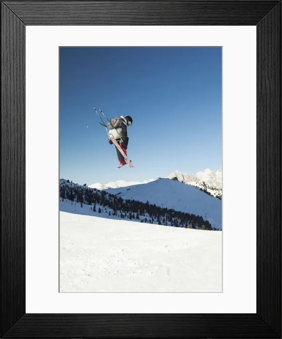 Framed Print : a view of a freestyler flying with his skis after a jump in Val Gardena, Bolzano province
