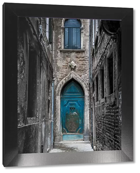 Venice, Veneto, Italy. Blue moorish door in a narrow street