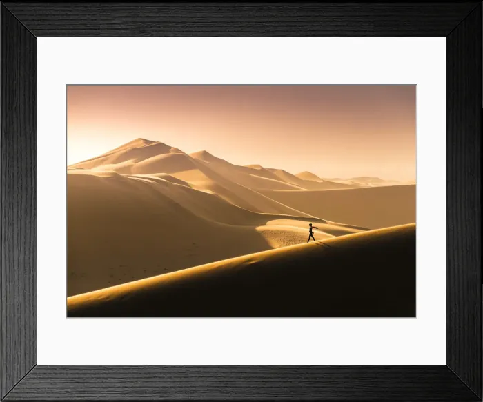 Framed Print : Walvis Bay, Namibia, Africa. Tourist walking on the sand dunes at sunset