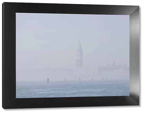 St Marks Bell Tower and Doges Palace in the mist; Venice, Veneto, Italy
