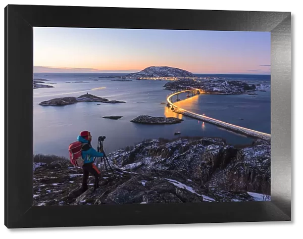 Photographer looks towards bridge and sea, Sommaroy island, Troms county, Norway (MR)
