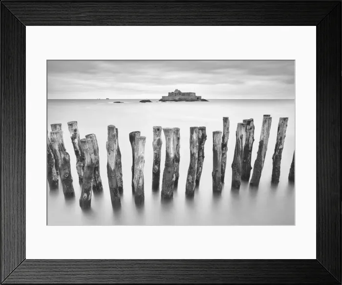 Framed Print : Wooden sea defence and Fort National at high tide, St