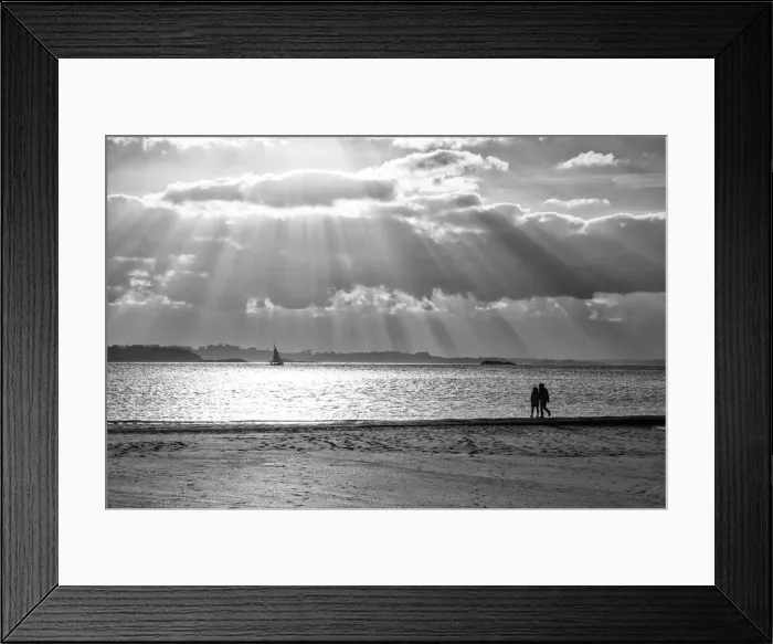 Framed Print : A couple walk along the plage du Mole at sunset, St Framed Print : A couple walk along the plage du Mole at sunset, St