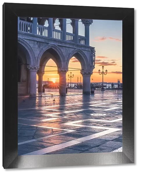 Venice, Veneto, Italy. Sunrise through the arches of Doges Palace in Piazzetta San Marco