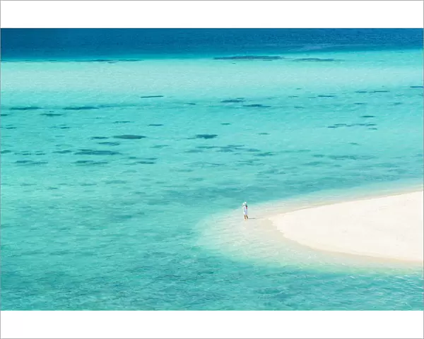 Ko Lipe, Satun Province, Thailand. Tourist admring the turquoise water from a white beach strand