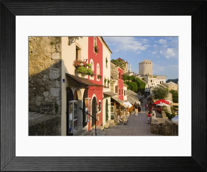Framed Print : Cobbled street lined with colourful houses Framed Print : Cobbled street lined with colourful houses