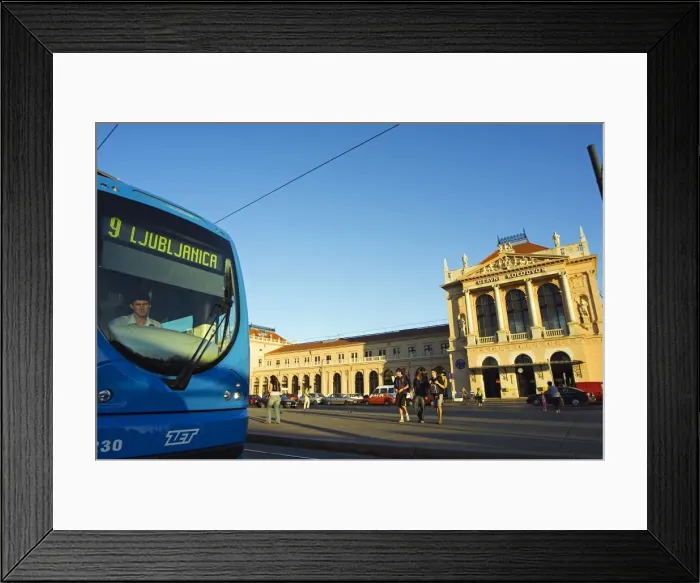 Framed Print : Tram Running past Train Station Framed Print : Tram Running past Train Station
