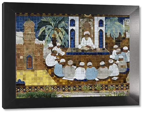 A ceramic panel depicting an Imam teaching the Koran