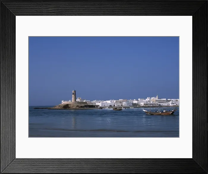 Framed Print : A fishing dhow motors across the lagoon towards Framed Print : A fishing dhow motors across the lagoon towards