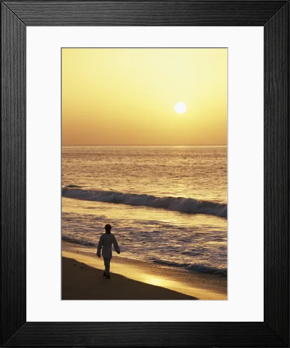 Framed Print : A warden walks along the beach at Ras al Jinz at sunrise Framed Print : A warden walks along the beach at Ras al Jinz at sunrise