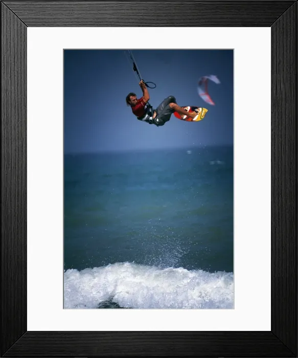 Framed Print : A kitesurfer makes a large tailgrab jump off Masirah Framed Print : A kitesurfer makes a large tailgrab jump off Masirah