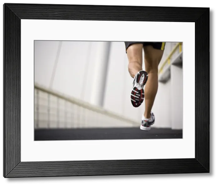 Framed Print : A man running across a bridge