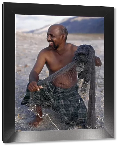 A fisherman near Di Hamri with his weighted throwing net