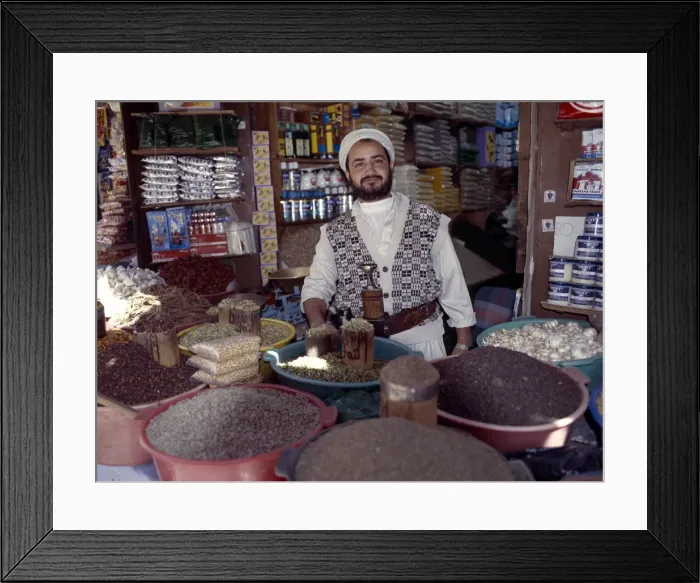 Framed Print : A Yemeni trader at his market stall in the old Suq
