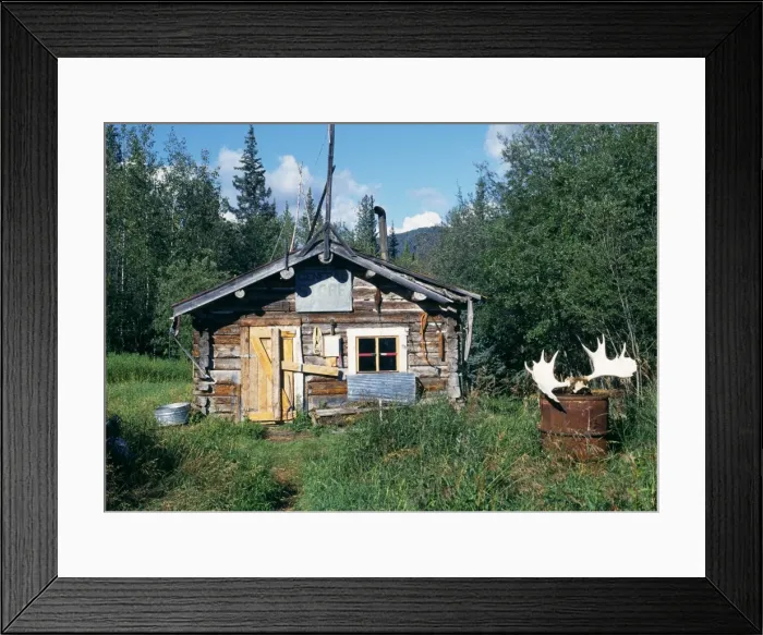 Framed Print : A log cabin inhabited during the winter Framed Print : A log cabin inhabited during the winter