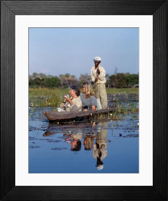 Framed Print : A boatman in his mokoro dug-out canoe takes tourists