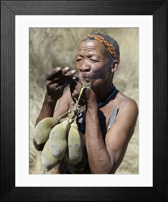 Framed Print : A N!!S hunter-gatherer lights his pipe to relax having Framed Print : A N!!S hunter-gatherer lights his pipe to relax having