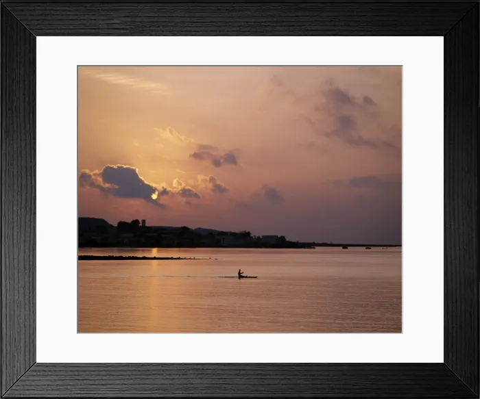 Framed Print : A fishermen paddles his small boat across Tadjoura Bay at sunrise Framed Print : A fishermen paddles his small boat across Tadjoura Bay at sunrise