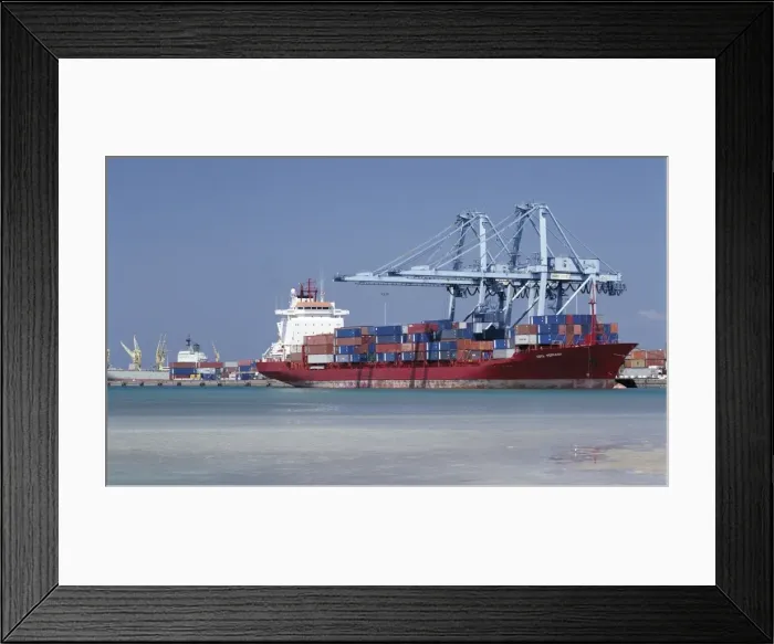 Framed Print : A large container vessel discharges its cargo at the port of Djibouti Framed Print : A large container vessel discharges its cargo at the port of Djibouti