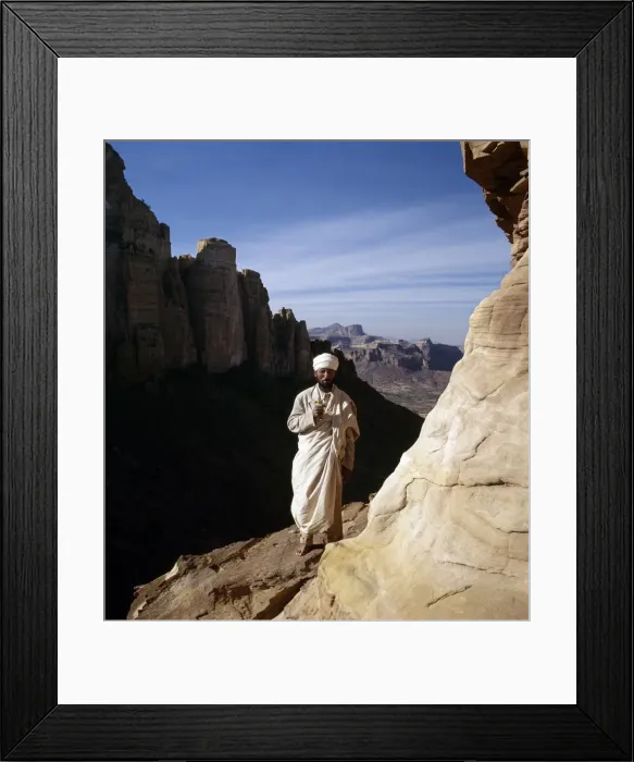 Framed Print : A priest stands outside the rock-hewn church of Abune Framed Print : A priest stands outside the rock-hewn church of Abune
