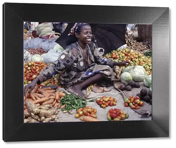 A woman sells vegetables at Bati market