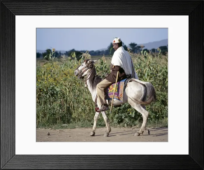 Framed Print : A man rides to market on his gaily-caprisoned pony Framed Print : A man rides to market on his gaily-caprisoned pony
