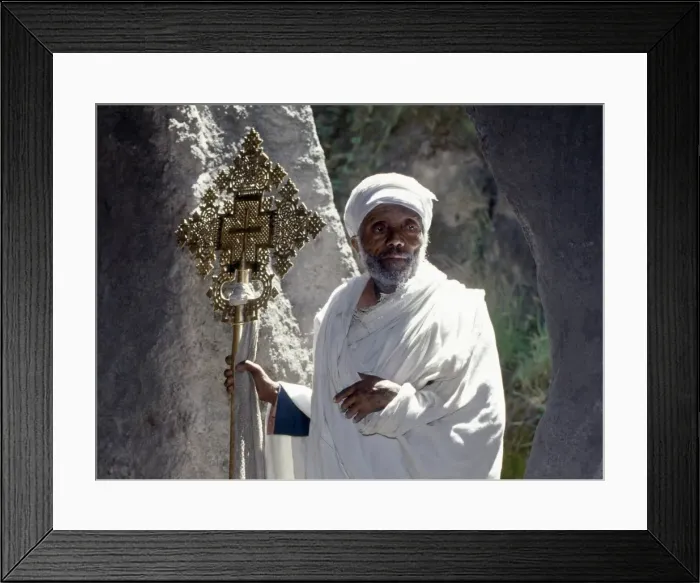 Framed Print : An old Ethiopian Orthodox priest holds a large brass