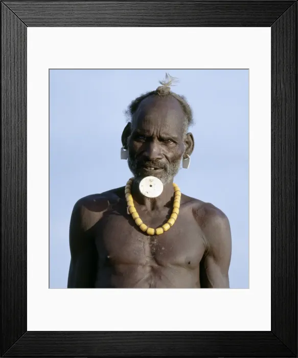 Framed Print : An old Dassanech man wearing a traditional lip ornament and earrings