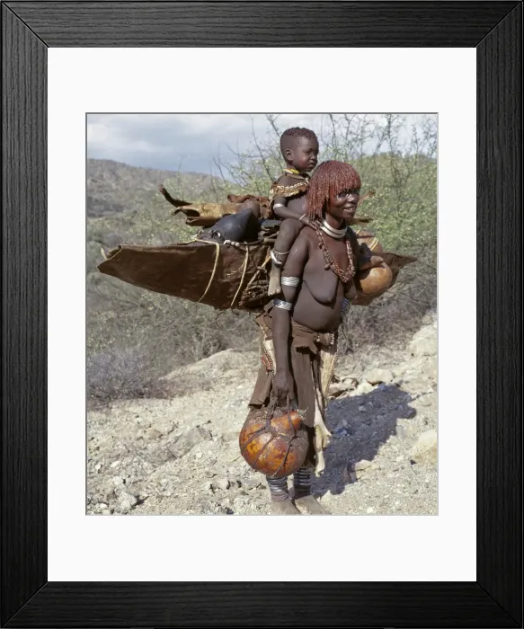 Framed Print : A Hamar mother and child moving home Framed Print : A Hamar mother and child moving home