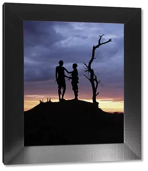 Two Hamar children silhouetted by the setting sun