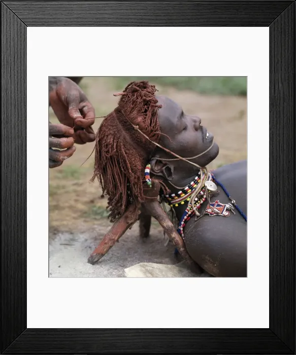 Framed Print : A Samburu warrior has his Ochred hair braided by a friend Framed Print : A Samburu warrior has his Ochred hair braided by a friend