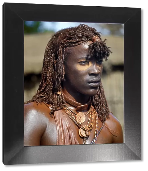 A Msai warrior with his long braids and body coated