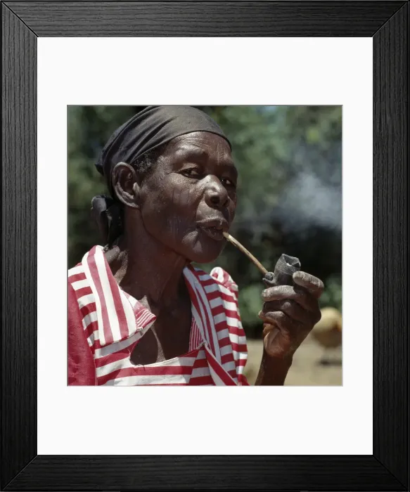 Framed Print : An old Luo lady smoking a traditional clay pipe Framed Print : An old Luo lady smoking a traditional clay pipe