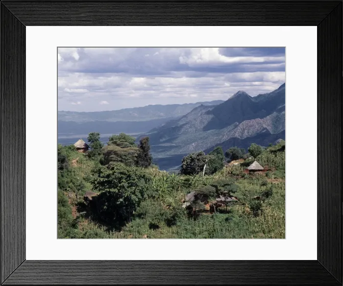 Framed Print : Traditional thatched homesteads perched on top of Framed Print : Traditional thatched homesteads perched on top of