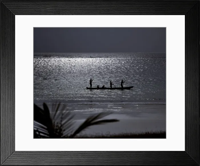 Framed Print : Three men pole a dugout canoe by moonlight in shallow water along Diani Beach Framed Print : Three men pole a dugout canoe by moonlight in shallow water along Diani Beach