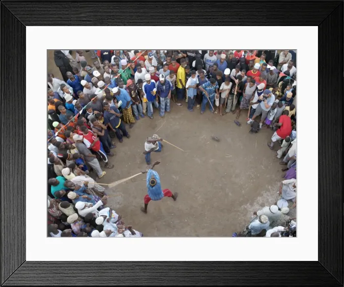 Framed Print : Lamu crowds watch a stick fight along the waterfront at Lamu town Framed Print : Lamu crowds watch a stick fight along the waterfront at Lamu town
