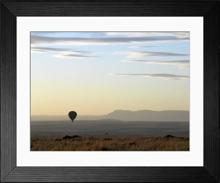 Framed Print : A hot air balloon floating over the Masai Mara Game Reserve at daybreak