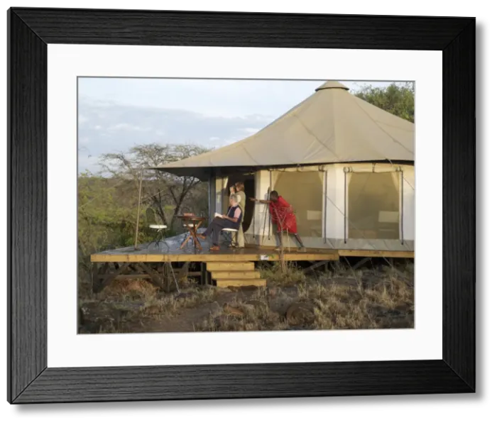 Framed Print : A Msai guide points out a wild animal to visitors Framed Print : A Msai guide points out a wild animal to visitors