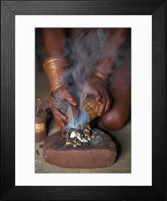 Framed Print : A Himba woman lights a small fire made of woodshavings Framed Print : A Himba woman lights a small fire made of woodshavings